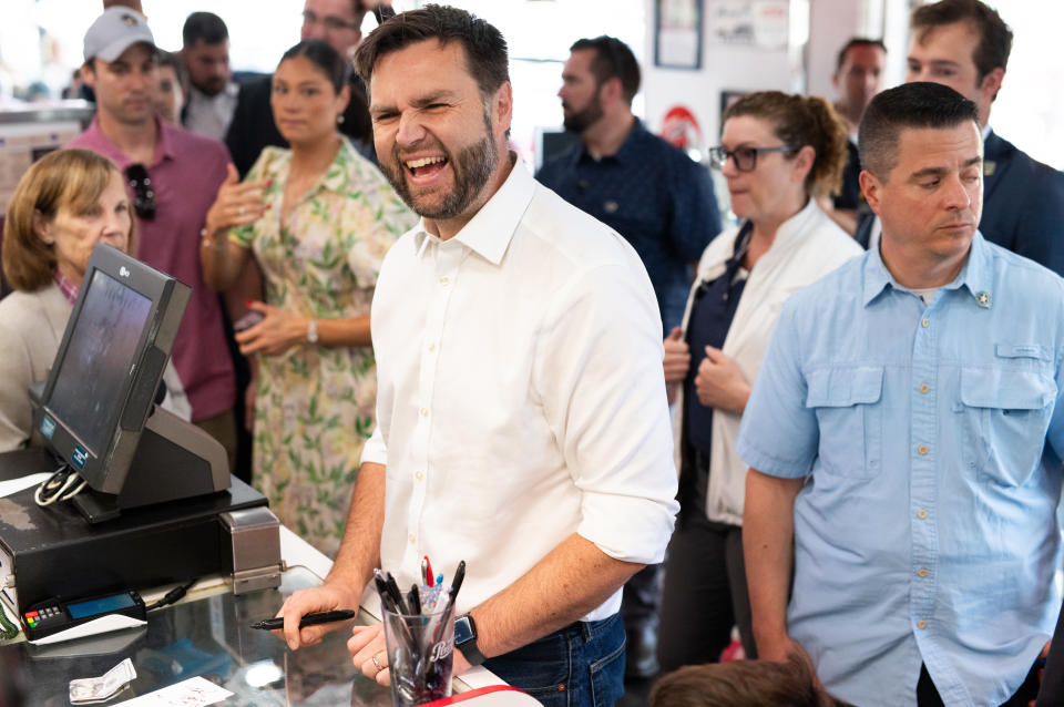 ST CLOUD, MINNESOTA - JULY 28: Republican vice presidential nominee U.S. Sen. J.D. Vance (R-OH) pays for a breakfast order as he and his family greet supporters at the Park Diner on July 28, 2024 in St Cloud, Minnesota. Vance joined U.S. Republican Presidential nominee former President Donald Trump for a campaign rally last night in Minnesota. (Photo by Stephen Maturen/Getty Images)